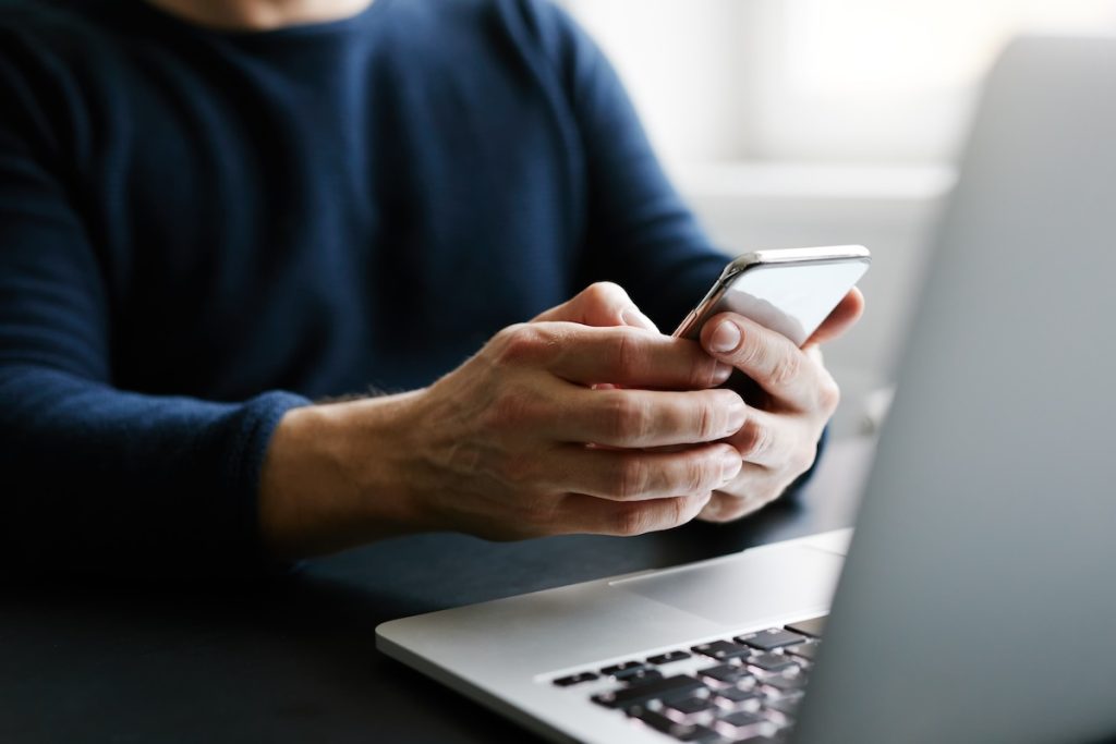 Selling your home after divorce | man on phone and computer